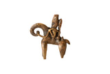 Vintage African bronze sculpture of two warriors riding an animal, with aged patina, 3 inches tall.