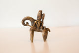 Time-softened bronze texture of the vintage African warrior sculpture.