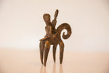 Side profile of a vintage African bronze warrior sculpture with an aged, matte finish.