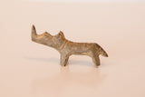 Side profile of a vintage African mini rhino showing its dusty bronze patina.
