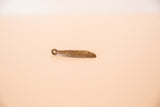 Side profile of the vintage African bronze pendant, highlighting its cast form and depth.