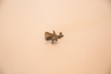 A high-angle view of the tiny vintage African bronze elephant sculpture.