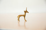 The golden surface and elegant profile of a vintage handmade bronze gazelle.