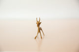 A frontal view of the vintage African bronze gazelle's delicate, handmade form.