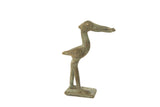 A vintage African bronze stork sculpture with an oxidized green patina, holding a fish.