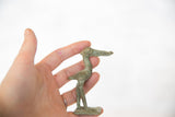 Vintage African bronze stork figure held in hand to show its collectible size.