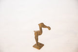Collectible bronze stork with fish, showing its stylized form and aged texture.