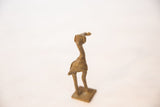 Handmade texture on the back of a vintage African bronze stork sculpture.