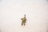 Small oxidized bronze elephant figure from behind with large ears and curled trunk.