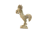Vintage African bronze rooster sculpture holding a snake, with a textured and oxidized patina.
