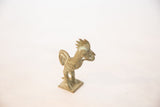 Angled view of a vintage bronze rooster, highlighting its stylized form and ridged texture.