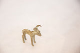 Angled profile of the vintage bronze antelope showing its textured, oxidized patina.