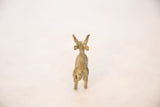 Vintage oxidized bronze antelope seen from behind, detailing the spine and tail.