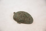 Vintage African copper head's intricate mesh texture with aged green patina.