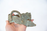 Side view of a vintage bronze snake bracelet highlighting its textured, handmade details.