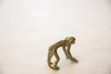 Side view of the vintage bronze monkey showing its detailed arched spine and patina.