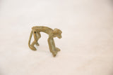 Vintage African bronze monkey sculpture, showing its detailed back and time-softened patina.