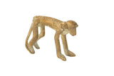 Vintage African oxidized bronze monkey figurine with a handmade texture and aged patina.