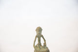 Detailed handmade face of the vintage African copper drummer with an oxidized finish.