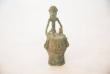 Front view of the vintage copper drummer showing the figure's stylized face and drum.