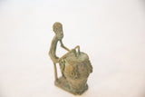 Profile view of the vintage copper drummer highlighting the figure's stylized pose.