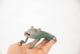 Vintage African copper feline with a textured green patina held in hand to show scale.