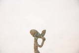 Aged verdigris patina on the abstract head and arms of the handmade copper figure.
