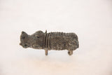 Side view of a vintage African boar collectible with textured, oxidized copper finish.