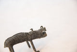 Close-up of the vintage copper boar's expressive face, showing its open mouth and dark oxidized finish.