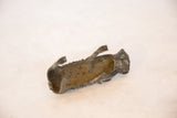 The aged, hollow interior revealing the handmade form of the copper boar.