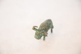 High-angle view showing the vintage copper bull's oxidized green patina.