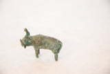 The vintage copper bull in profile, detailing its handmade form and green patina.