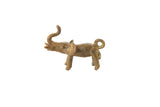 Vintage African bronze elephant pendant with a rustic patina, raised trunk, and looped tail.