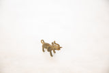 Handmade bronze elephant pendant, showcasing its textured surface and curled trunk.