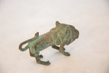 Vintage African wild thing's textured back and curved tail with green patina.