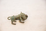 Vintage African wild thing sculpture, side view with oxidized copper patina and textured surface.