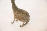 Textured spiral patterns detail the oxidized copper body of a vintage chubby giraffe.