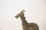 Close-up of the vintage copper giraffe's head, highlighting its rustic oxidized patina.