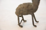 Slender handmade legs and feet of the oxidized copper giraffe figure.