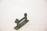 The long, textured body and prominent curled tail of a vintage African copper monkey.