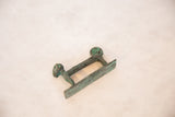 Angled view of the long copper monkey highlighting its vintage oxidized patina.