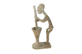 Vintage African copper figurine of a woman churning butter with an oxidized patina.