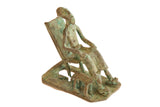 Vintage African copper statue of a seated man and dog, showing green patina.