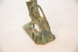 Green patina and textured surface on vintage copper dog and seated man.