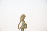 Stylized facial features and rich patina on the vintage oxidized copper drummer figure.