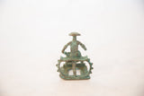 Front view of a vintage African oxidized copper woman figure on a spiked throne.