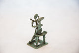 Detail of African copper mother with child on lap figurine, showing textured patina.