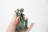 Detail view of the vintage African copper sculpture, showing its rich green-blue patina.