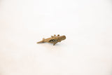 Bronze fish pendant's open mouth reveals its unique mesh design.