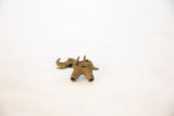 Angled view of the vintage bronze elephant pendant highlighting the wire-wrapped back.